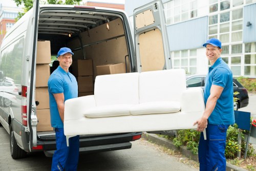 Furniture pick-up service removing a sofa in Bethnal Green