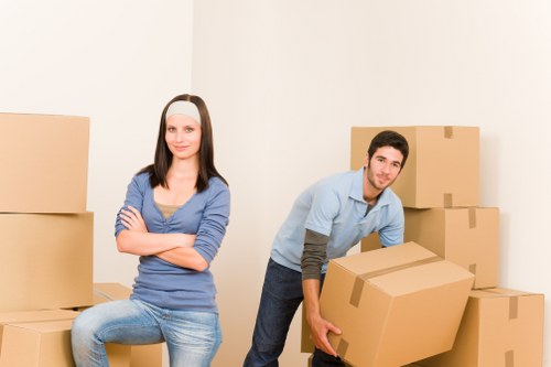 Trained moving staff using PPE while lifting items carefully