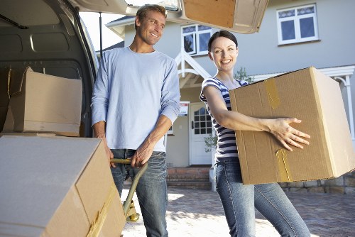 Professional movers loading boxes into a van in East London